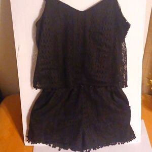 Short romper laced with fringed balls on top and bottom of romper